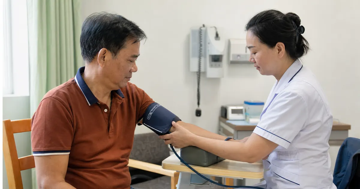 International patient having blood pressure measured during a health checkup in China